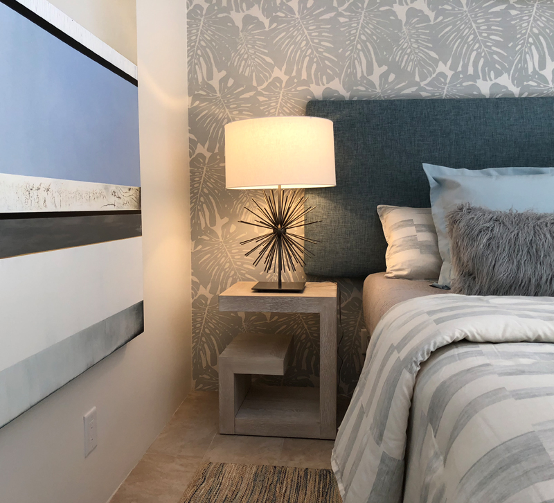 Gray and blue bedroom with table lamp on nightstand