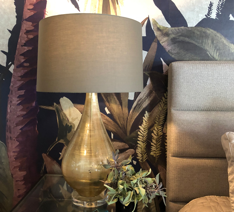 Gold table lamp on bedside table