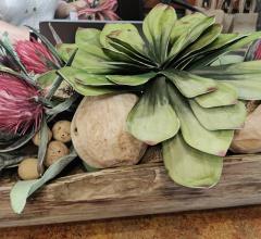 green and pink botanicals in a horizontal wooden holder