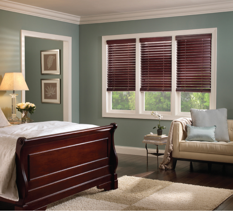 Automated Lutron Venetian shades shown in a bedroom