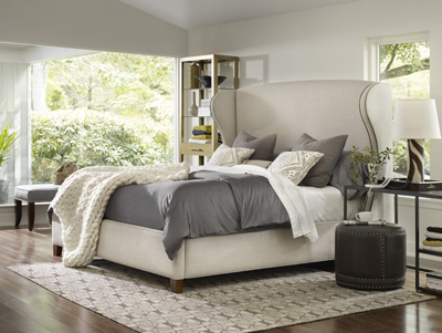 Nest Theory headboard in gray on a bed, designed by Hooker Furniture