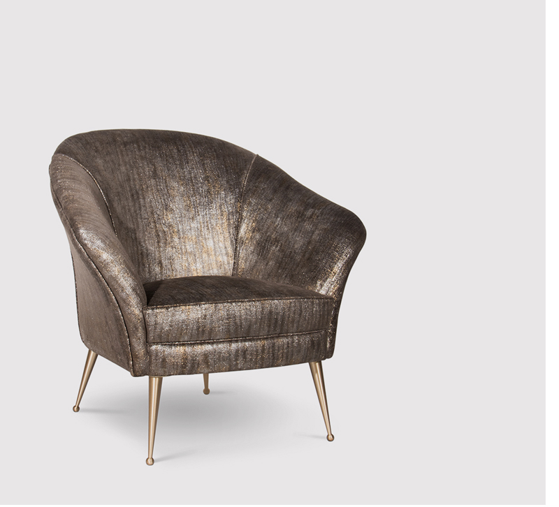MEtallic covered Chiclet accent chair with a high, rounded back and brass legs from Koket