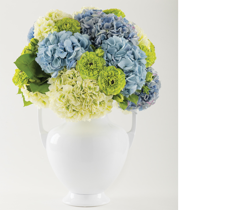 White vase with blue, white and green flowers