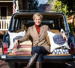 Kerrie Kelly sits on the back of her car with a few of her favorite products