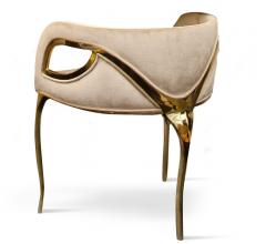 Chandra accent chair with gold arms and a plush seat and back