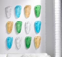Amber, blue, green and clear glass faces wall decor on wall from Phillips Collection