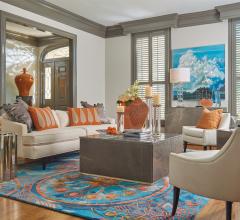 LIving room with beige couch and chairs and blue and orange rug by Global Views
