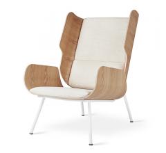 Elk chair with rounded wooden sides, white cushions on the seat and back and white, skinny legs from Gus Modern