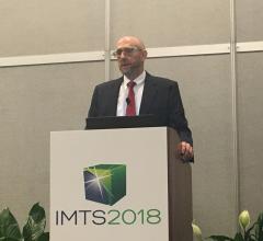 Reshoring Intiative's Harry moser speaking to a crowd of reporters at IMTS 2018 in Chicago