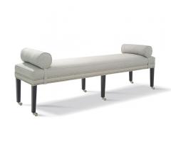 Brunswick King Bench with gray fabric with a nailhead trim and six black legs on wheels from Taylor King