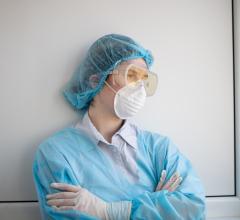woman in blue scrub suit and mask
