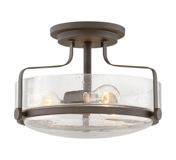 Harper Flush Mount in Oil-Rubbed Bronze with seeded glass surrounding two Edison bulbs from Hinkley Lighting