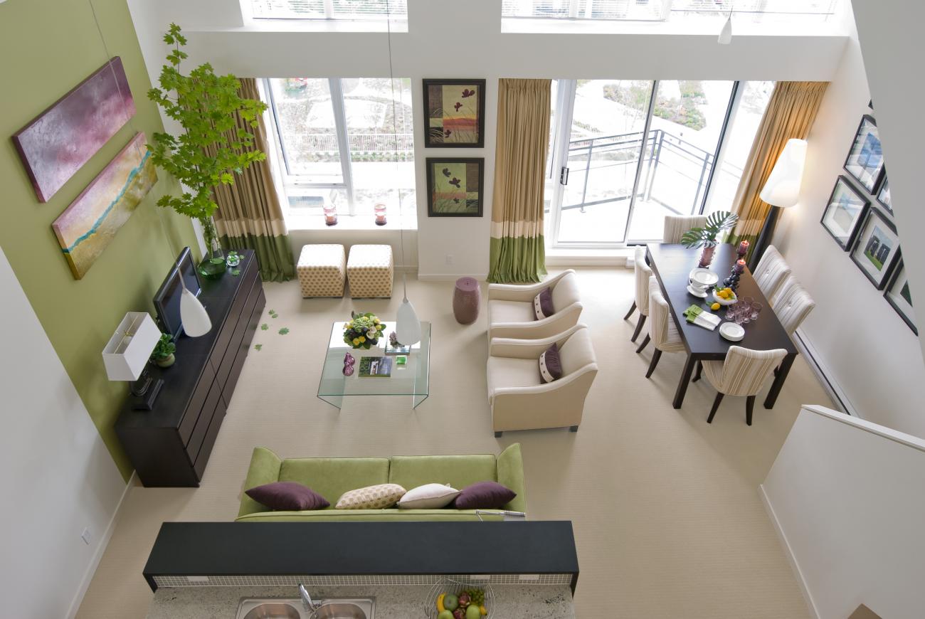 Living room with large windows and one wall painted green 