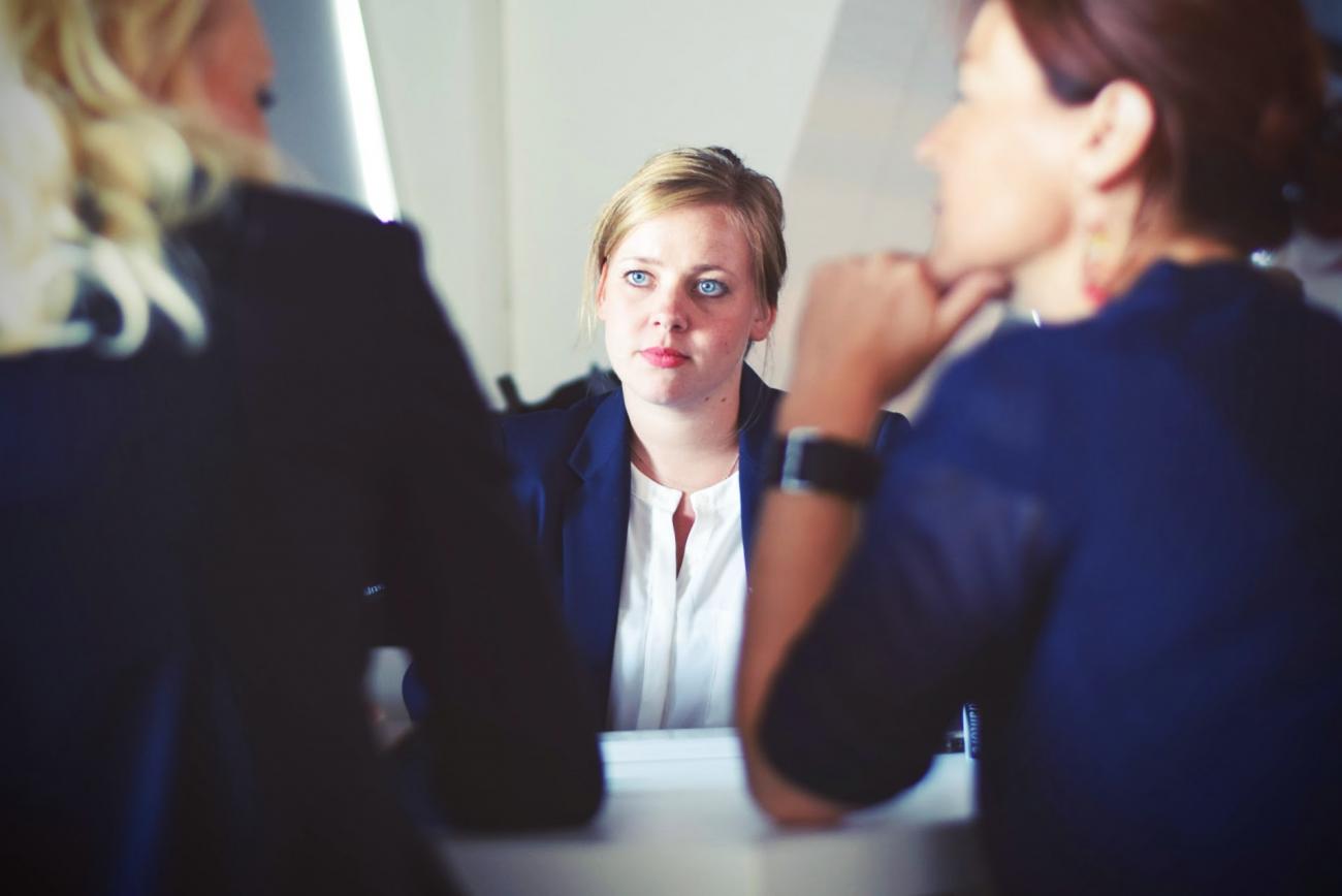 Stock photo of two women interviewing a third woman