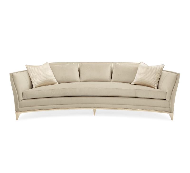 Bend the Rules sofa in a crescent shape with a wood base in Soft Silver Leaf from Caracole