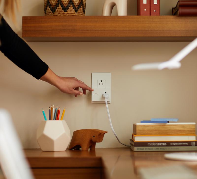 Woman using Legrand smart lighting switch