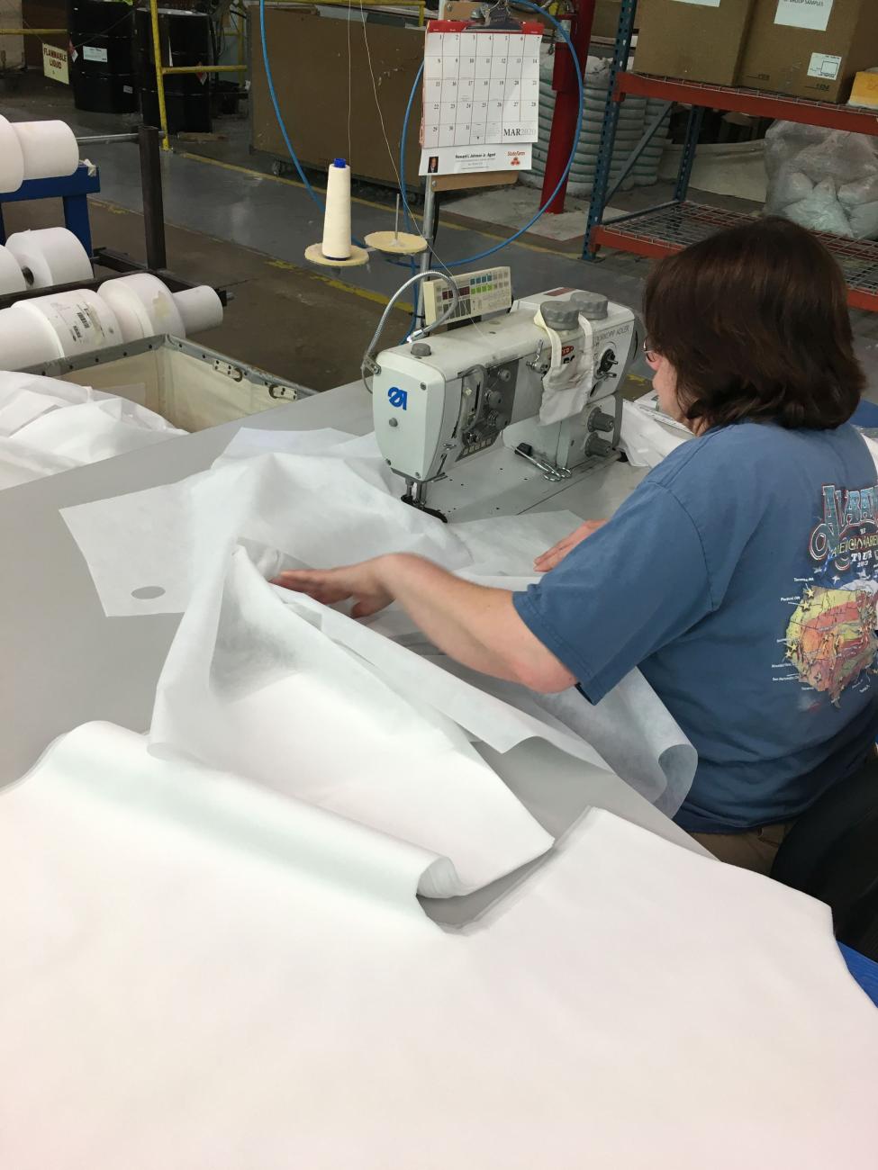 HSM employee sewing medical gowns