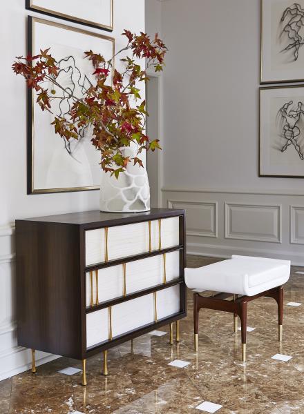 In Handley Drive’s Cavalcade chest, a dark American Walnut exterior frames Italian white ash panels. The contrasting polished brass flared column pulls have random but balanced placement for a bold statement. www.handleydrive.com