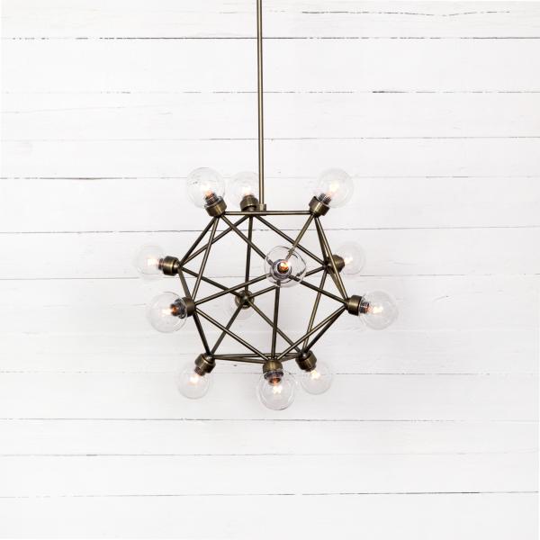 Four Hands: This industrial-looking Claridge chandelier displays raw materials offsetting delicate glass bulbs. Iron is finished in Flat Brass. Three pipe sizes offer varying length options. A140. www.fourhands.com
