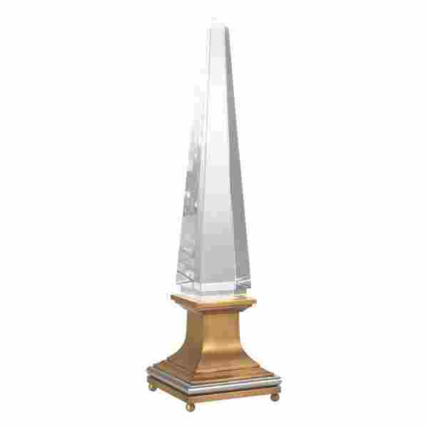 Impressive and glowing, the Illuminated Crystal Obelisk from Global Views stops the show with its solid crystal obelisk on top of a brass and nickel finished base. The base holds an LED bulb. www.globalviews.com